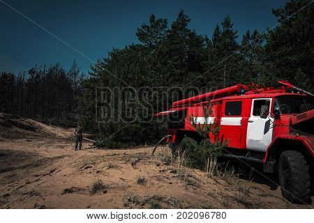 fire truck to put out a forest fire. firefighters to extinguish the fire. wildfire