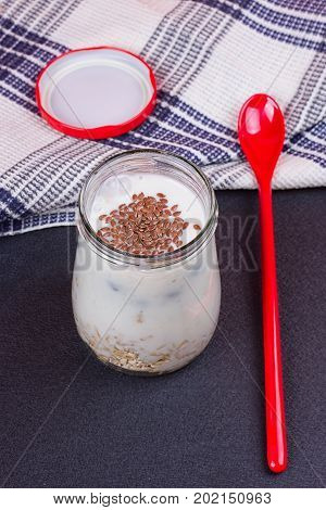 Healthy breakfast - yogurt with blueberries and muesli served in glass jar Lazy oatmeal