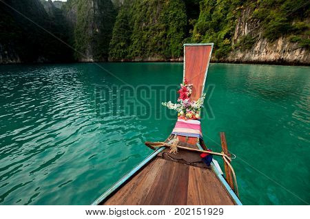 Old wooden boat on Asian Islands. Asian Islands. Thai Phi Phi Islands. Thai wooden boat. Boat in the Bay. Travelling to Asia. Travel to Thailand. Lagoon on the island. Boating around the island