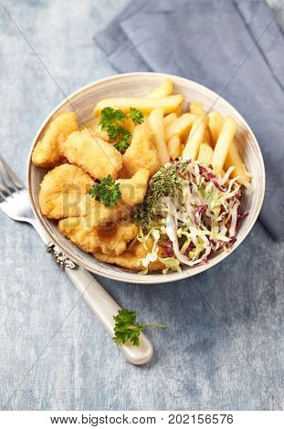Chicken nuggets with cabbage salad and french fries