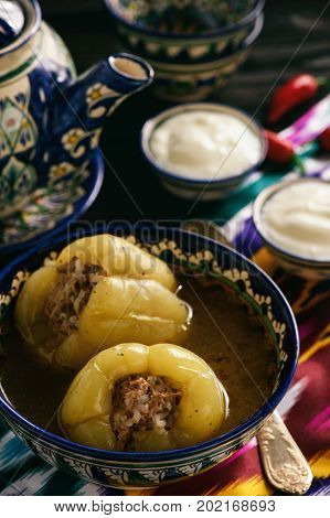 Stuffed peppers with broth, oriental uzbek style cuisine.