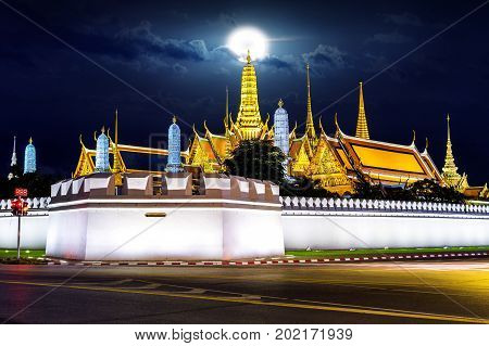 Wat phra keaw with full moon at night in Bangkok Thailand.