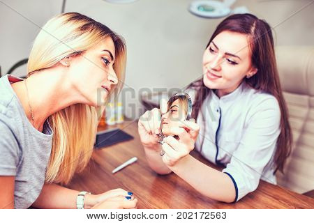 Smiling visitor listening beautician in medicine center