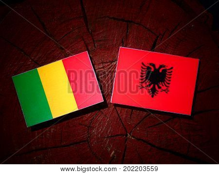 Malian Flag With Albanian Flag On A Tree Stump Isolated
