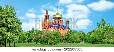 The Church of THE HOLY APOSTLES AND THE GOSPEL JOHN OF BOGHOSLOV in Pokrov city in Ukraire. Panorama of the holy Christian temple in the park in summer