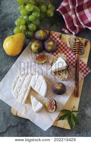 Goat cheese figs fruits and bread. Top view