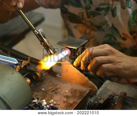 Glassmaker While Melting And Shaping The Glass With A Very High