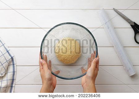 Step By Step Recipe Galette Or Pie With Nectarines. Female Hands Cover The Dough With Plastic Wrap.