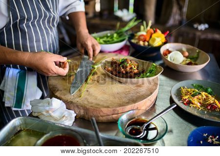 Chef making traditional cambodian meat dish at cooking class