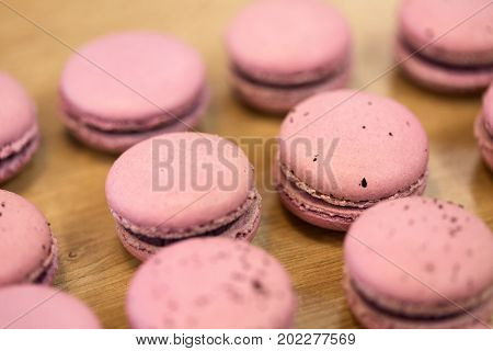 cooking, confectionery and baking concept - macarons on table