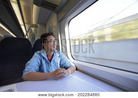 man smie and look somewhere on the train