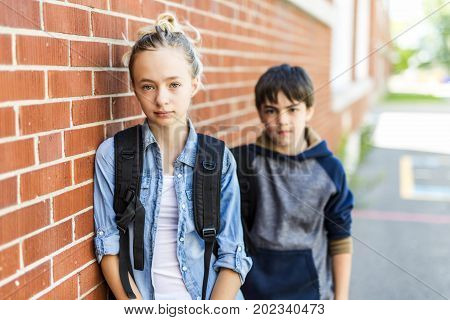 A Portrait of school 10 years boy and girl having fun outside