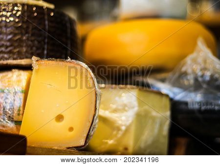 Cheese wheels placed on the couter at the deli