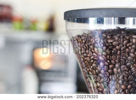 Coffee beans inside a grinder in a coffee shop
