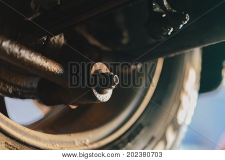 Car wheel bottom view. Garage mechanic raised the car on the lift. Object photo.