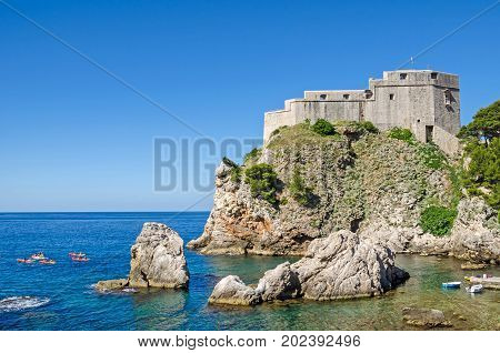Fort Lovrijenac or St. Lawrence Fortress often called Dubrovnik's Gibraltar a fortress and theater outside the western wall of the old city of Dubrovnik in Croatia with the Adriatic Sea and tourists boats.