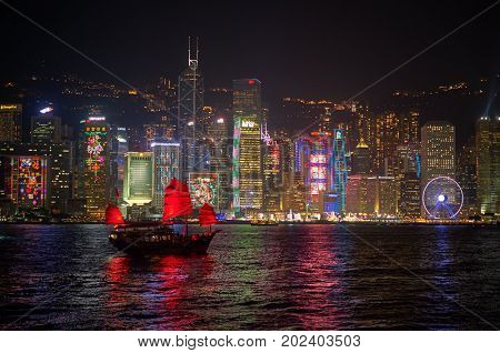 HONG KONG - JANUARY 25, 2016: The Aqua Luna sail around Victoria Harbour in the night. The Aqua Luna is a Chinese Junk operating in Victoria Harbour, Hong Kong