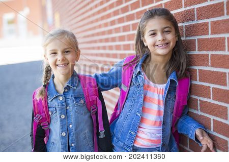 two childs girls at elementary school outside