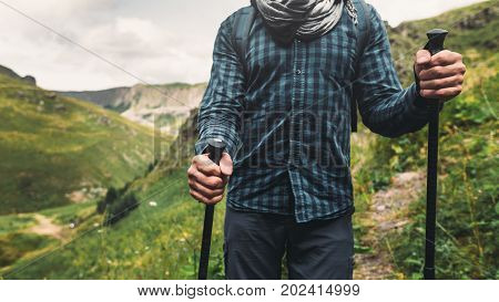 Young Hiker Man With Backpacks And Sticks Walking On A Mountain. Travel Adventure Outdoor Concept