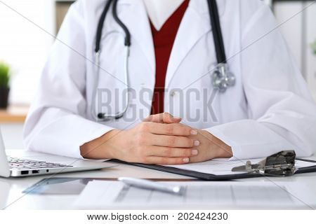 Close up of a unknown female doctor's hands. Physician is ready to consult and halp patients. Medicine and health care concept