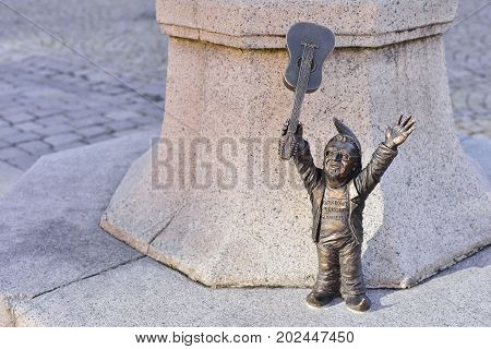 WROCLAW POLAND - JUNE 2017: Wroclaw a miniature statue of a gnome on the main square of the city. A dwarf with a guitar. The concept of music.