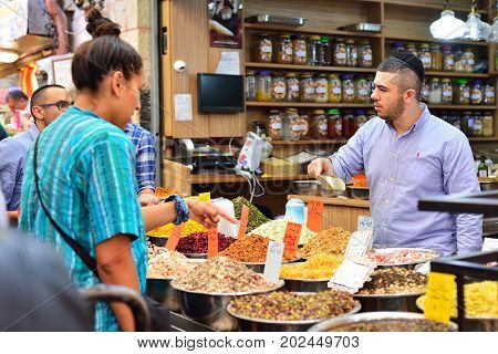 JERUSALEM ISRAEL - APRIL 2017: Market sketch Israeli trade seller and buyer in Israely Market Mahane Yehuda Jerusalem
