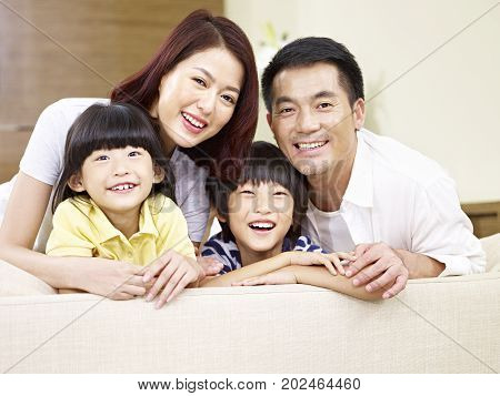 portrait of an asian family with two children happy and smiling.