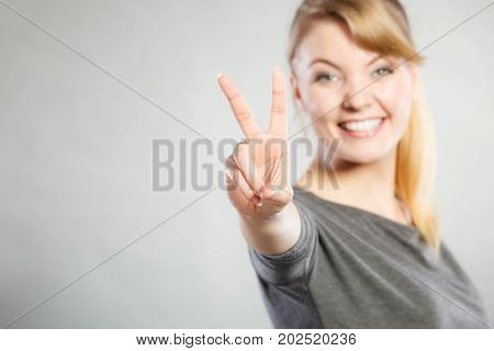 Cheerful Lady Makes V Gesture.