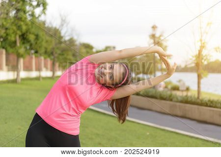 Pretty woman stretching the body before the running in thepark .Fitness beautiful woman concept.