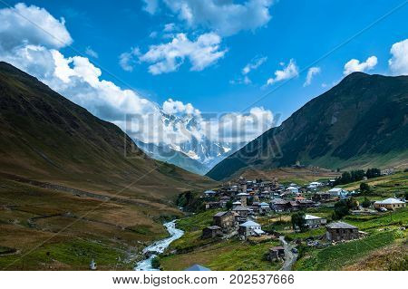 Village Ushguli Landscape With Massive Rocky Mountains Bezengi Wall, Shkhara On The Background In Sv