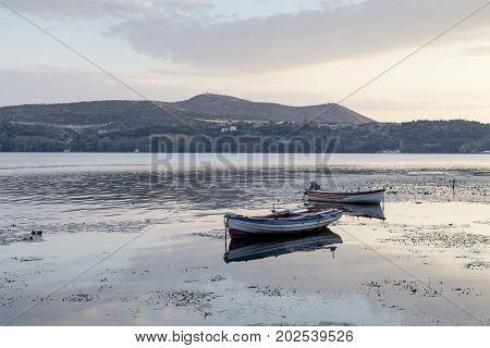 A boats on the background of the city lake Orestiada in the town of Kastoria in the evening (Macedonia, northwest Greece)