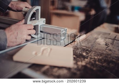 A Carpenter Works On Woodworking The Machine Tool. Saws Furniture Details With A Circular Saw
