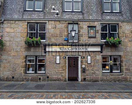 ABERDEEN, SCOTLAND: JULY 24: Exterior facade of the Ma Cameron's pub in the evening on  July 24, 2017 in Aberdeen, Scotland. Ma Cameron's  is a popular Aberdeen watering hole.