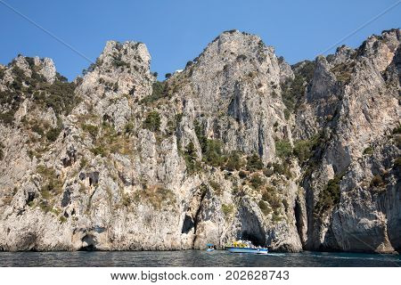 CAPRI ITALY - JUNE 13 2017: Boats with tourists near Grotta Bianca and Grotta Meravigliosa Capri Italy