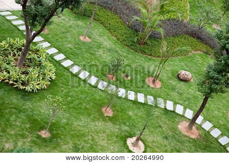 Stepping stones through a  tranquil garden in China
