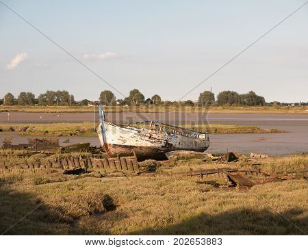 Moored Old Rusted White Wooden Boat Big In The Sun Light At Edge Of River Black Water Maldon