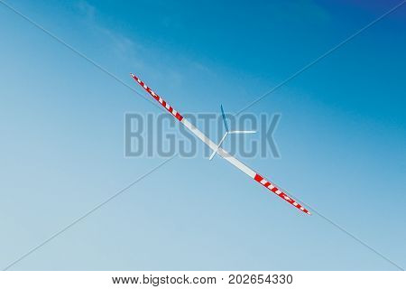 RC remotely controlled soaring plane model sailplane on blue sky in brisk wind