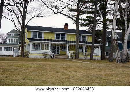 WEQUENTONSING, MICHIGAN / UNITED STATES - MARCH 30, 2017: A large yellow home on Beach Drive in Wequetonsing.