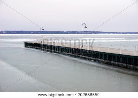 The dock in Wequetonsing, Michigan, during March, when ice still covers Little Traverse Bay.