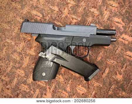 BANGKOK, THAILAND -  03 SEP 2017: Sig sauer P228 airsoft 6 mm bullet ball pistol gun on the floor