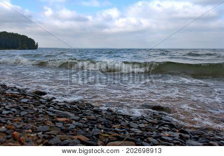 incoming wave on the shore in windy weather, South Ural lake Uvildy