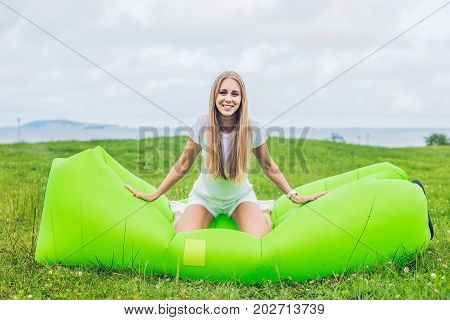 Young Woman Resting On An Air Sofa In The Park.