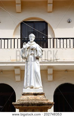 Monk statue outside the Parish church of our lady of sorrows Bugibba Malta Europe.