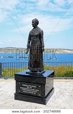 BUGIBBA, MALTA - MARCH 29, 2017 - Statue of Markiza Anna Bugeja on the waterfront with views across St Pauls Bay Bugibba Malta Europe, March 29, 2017.