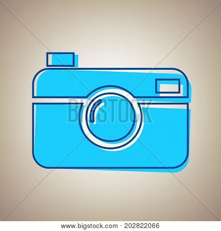 Digital photo camera sign. Vector. Sky blue icon with defected blue contour on beige background.