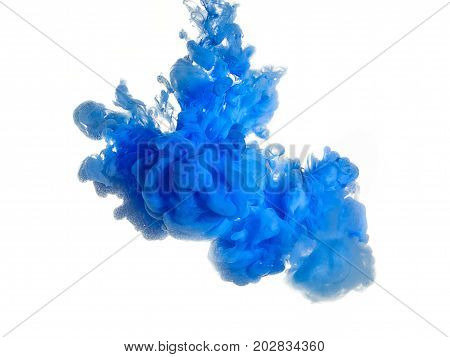 Ink swirl in water isolated on white background. The paint in the water. Soft dissemination a droplets of blue ink in water close-up. Abstract background. Soft focus.