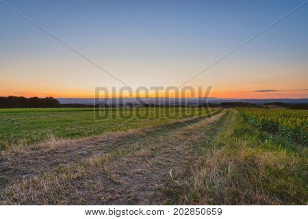 Heroic summer evening with beautiful sunset and twilight colors above the Rhône vally. In the distance view of the Ardeche and the city of Valence
