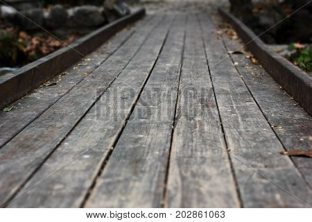 Old small wooden bridge in the forest