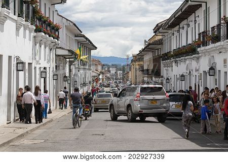 July 6, 2017 Popayan, Colombia: balconies decorating the white wash colonial buildings in the busy historic centre of the tourist destination