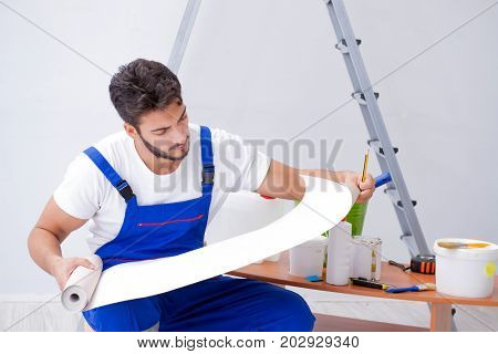 Repairman doing renovation repair in the house with paper wallpa